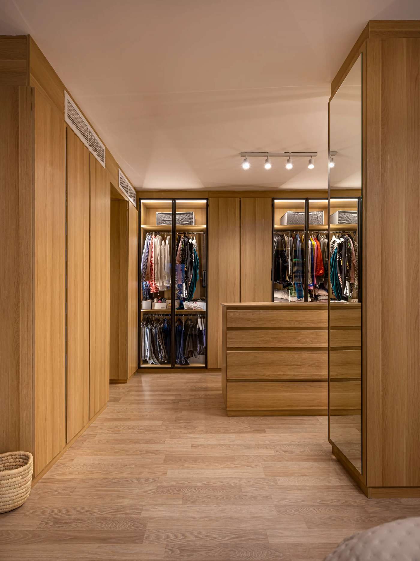 Custom walk-in closet suite in oak with glass-fronted wardrobes, by Modoro