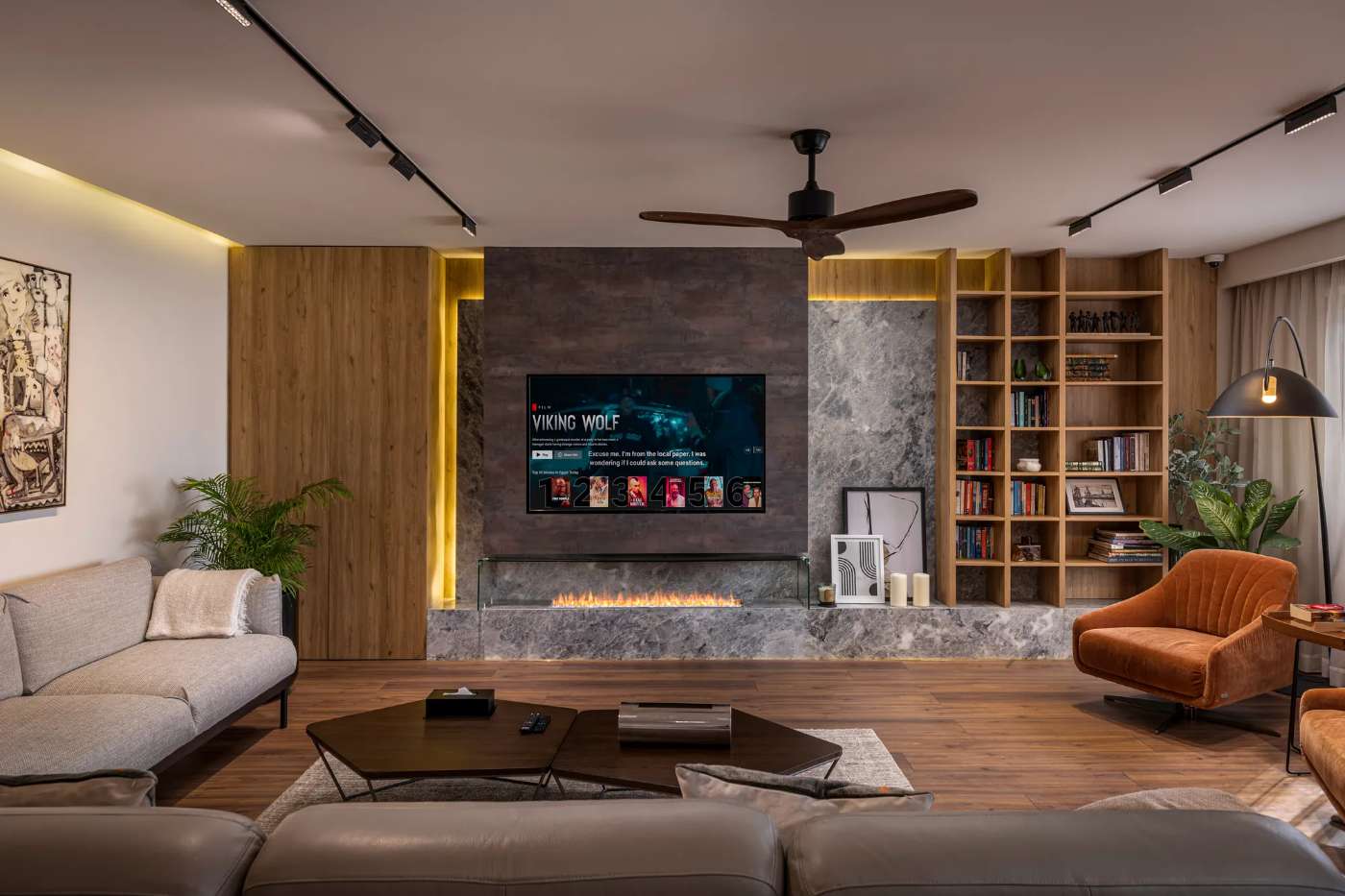 Custom media wall with stone cladding and oak library shelving, by Modoro