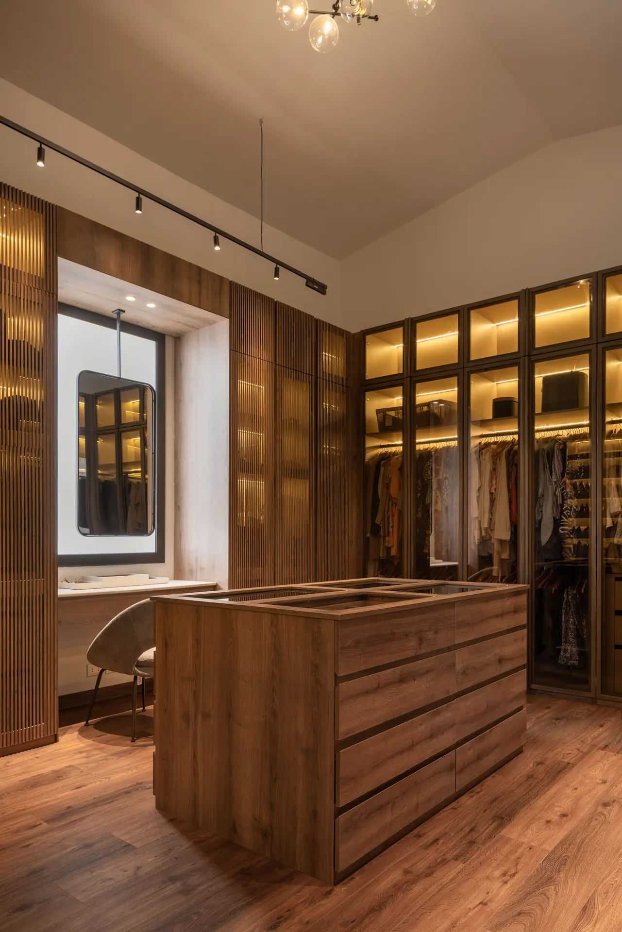 Walk-in closet with lit shelving and island, Allegria Villa