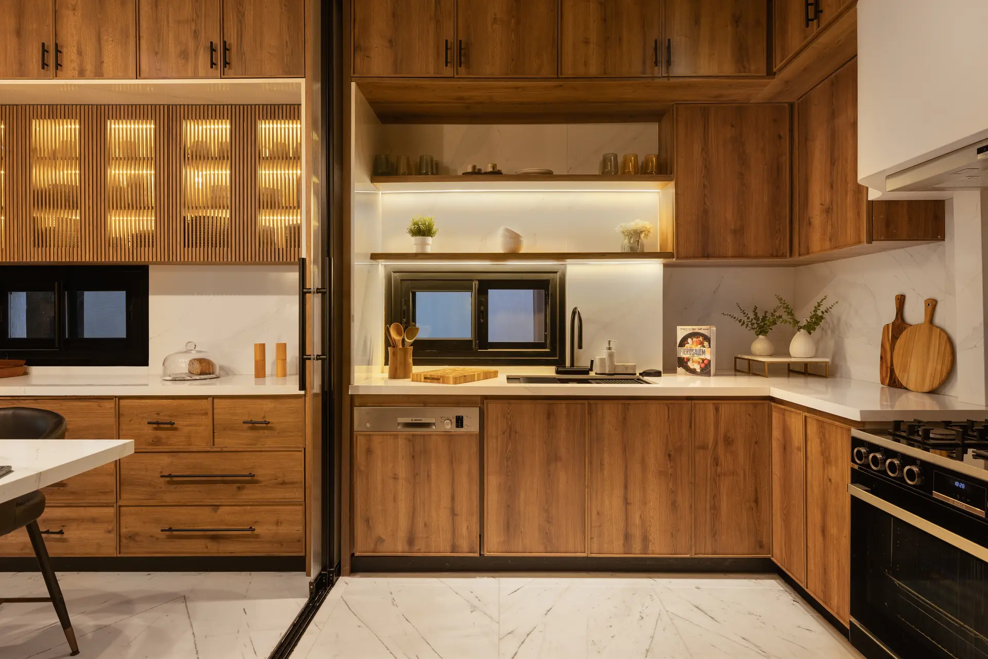 Oak kitchen cabinetry with lit glass upper units, Allegria Villa
