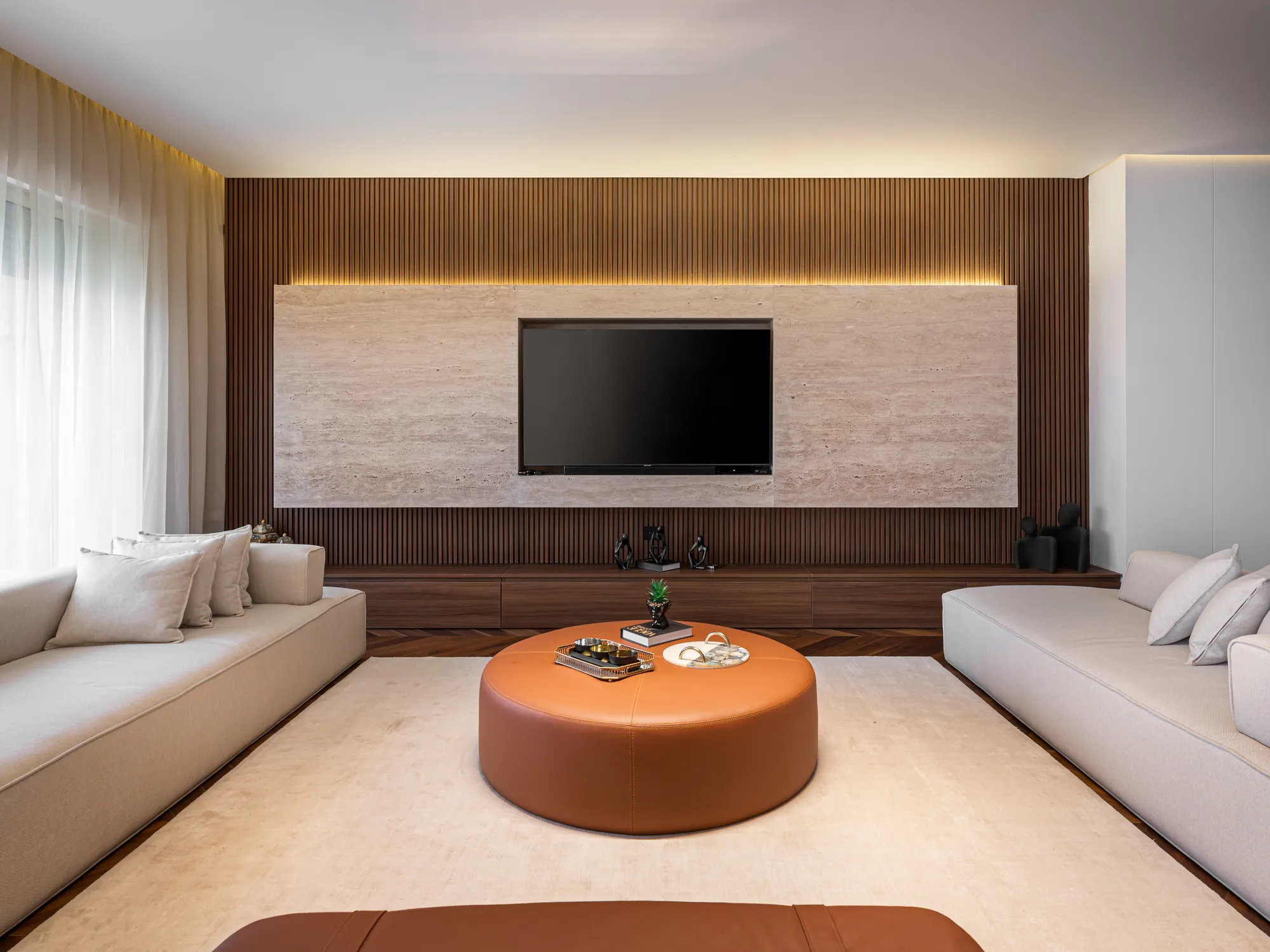 Symmetrical living room facing a travertine TV wall, New Giza Villa