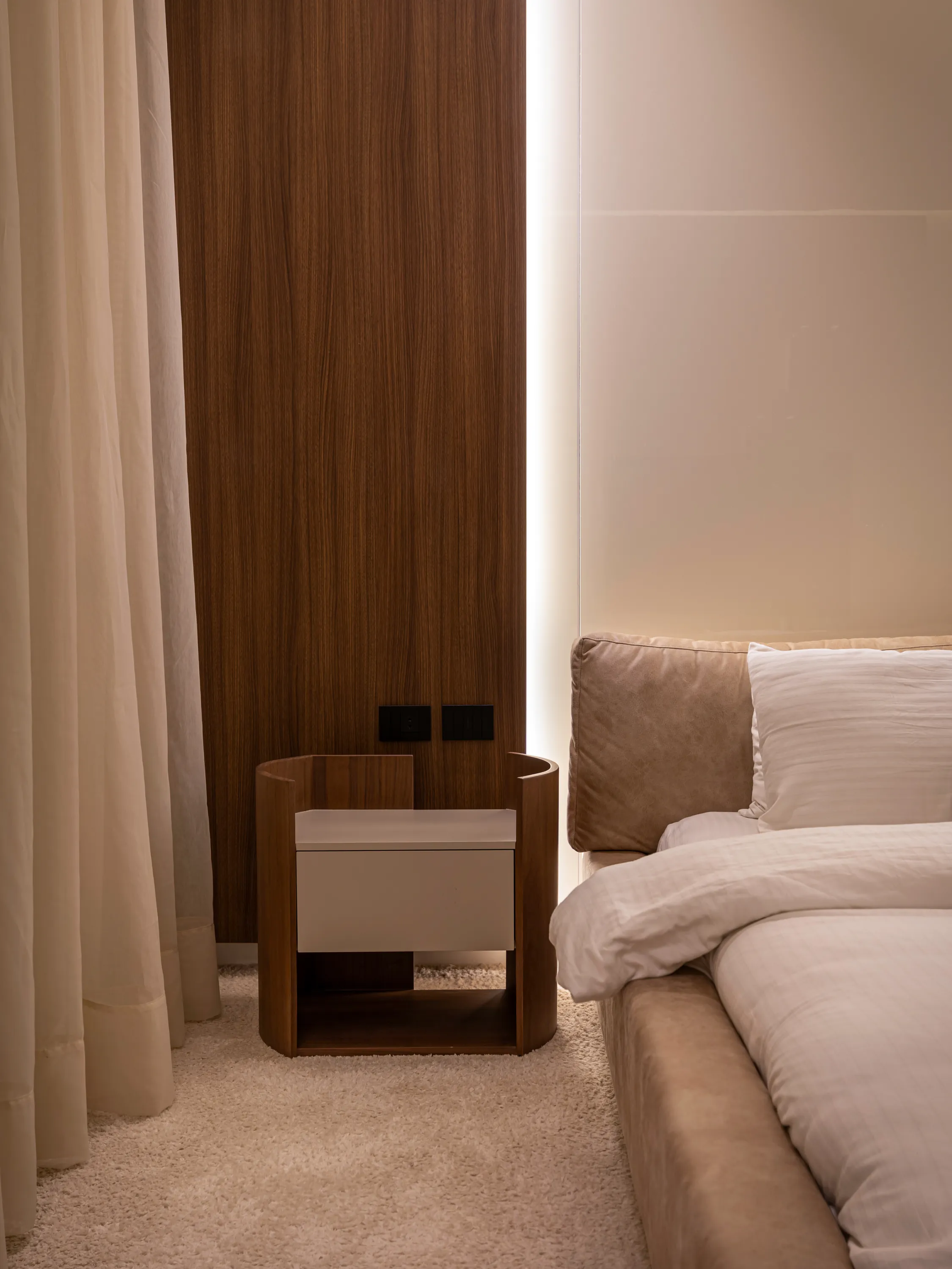 Walnut bedside unit beside an upholstered bed, New Giza Villa