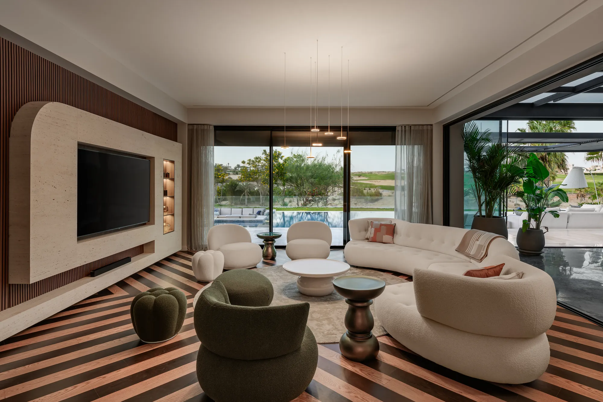 Curved media wall in a living room, Palm Hills Residence
